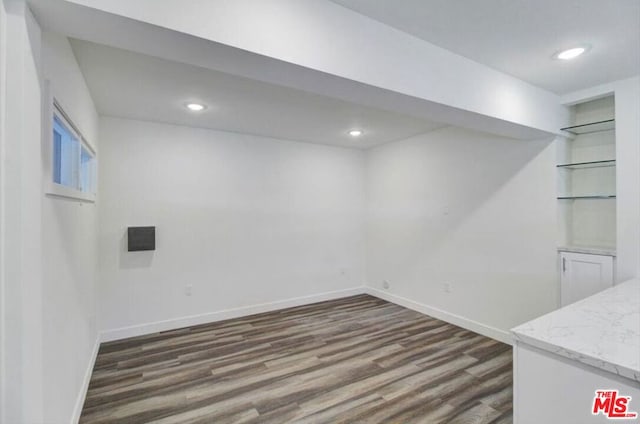 basement featuring dark hardwood / wood-style flooring