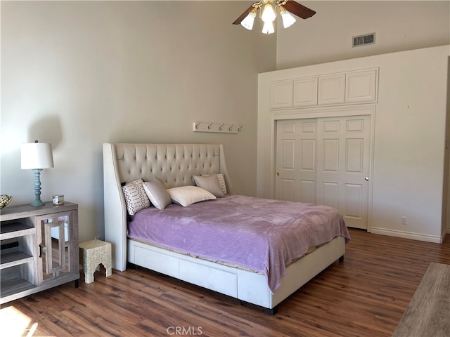 bedroom featuring a closet, ceiling fan, and dark wood-type flooring