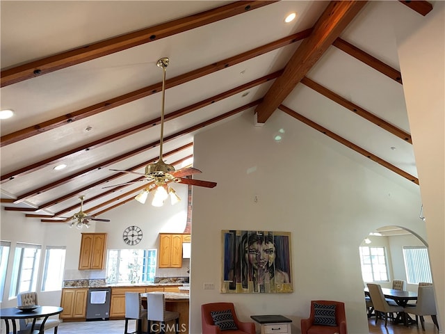 interior space featuring beam ceiling, high vaulted ceiling, and sink