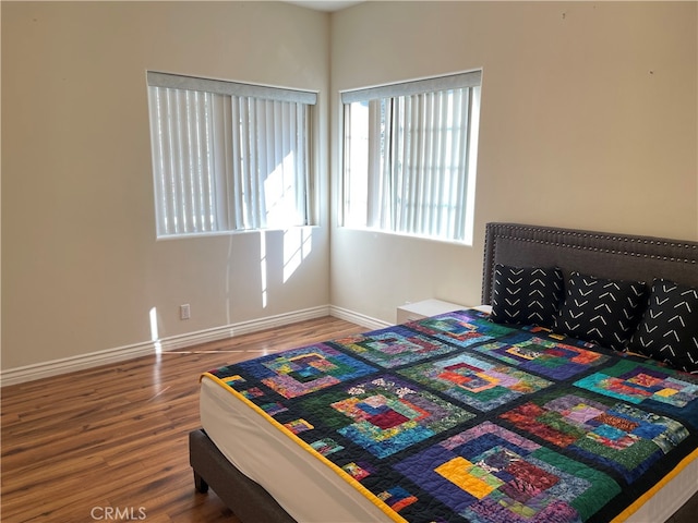 bedroom with wood-type flooring