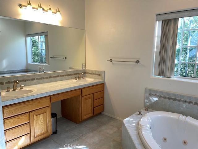 bathroom with vanity, tiled tub, and tile patterned flooring