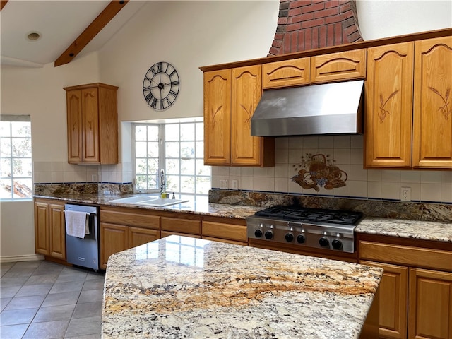 kitchen with beam ceiling, appliances with stainless steel finishes, sink, and a wealth of natural light