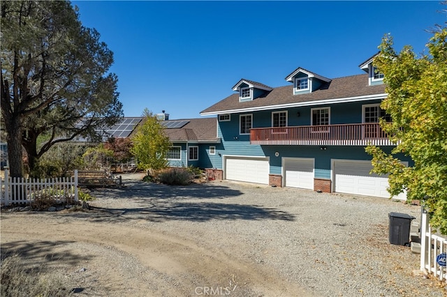 view of front of property with a garage and solar panels