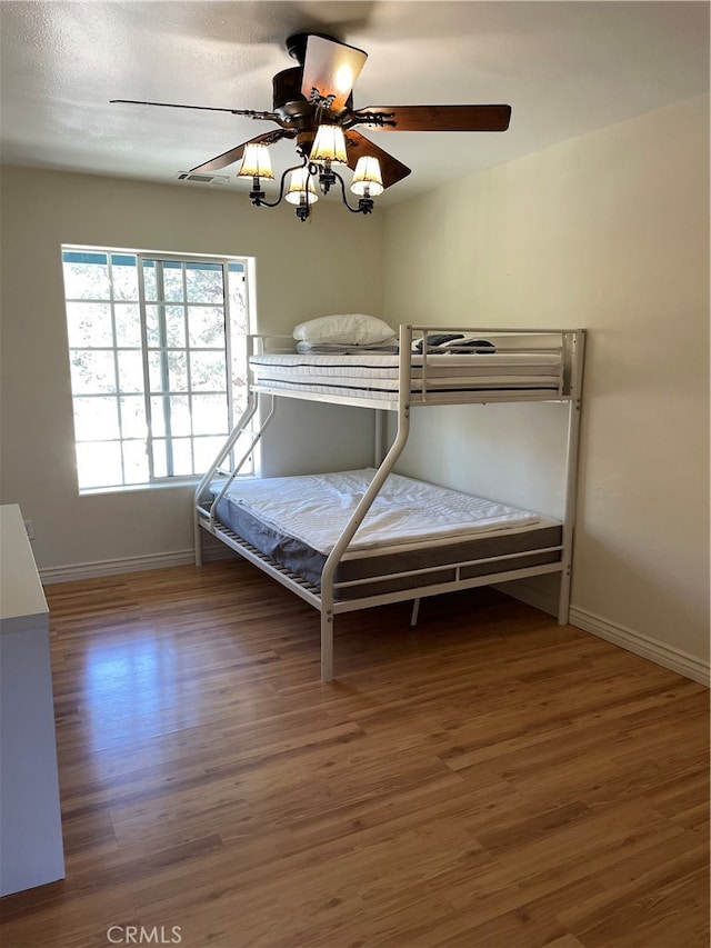 unfurnished bedroom with wood-type flooring and ceiling fan