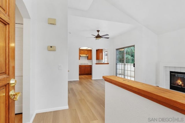 hall featuring lofted ceiling and light hardwood / wood-style flooring