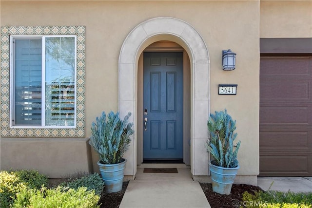 view of exterior entry featuring a garage