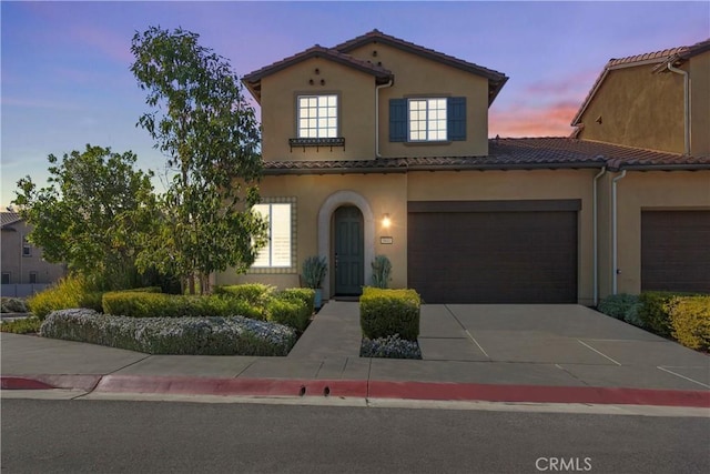 mediterranean / spanish-style house featuring a garage