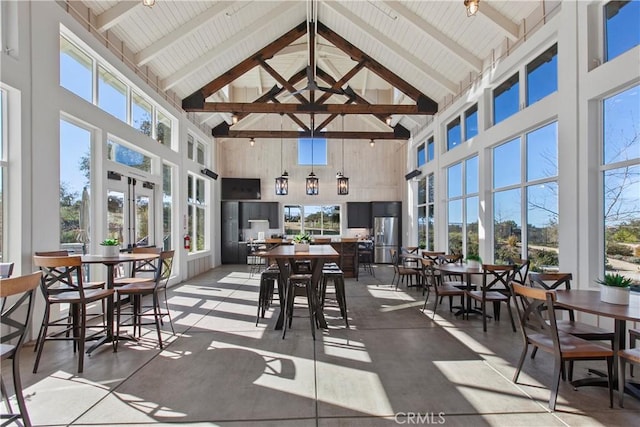 sunroom with lofted ceiling with beams