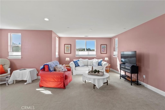 living room with a wealth of natural light and light colored carpet