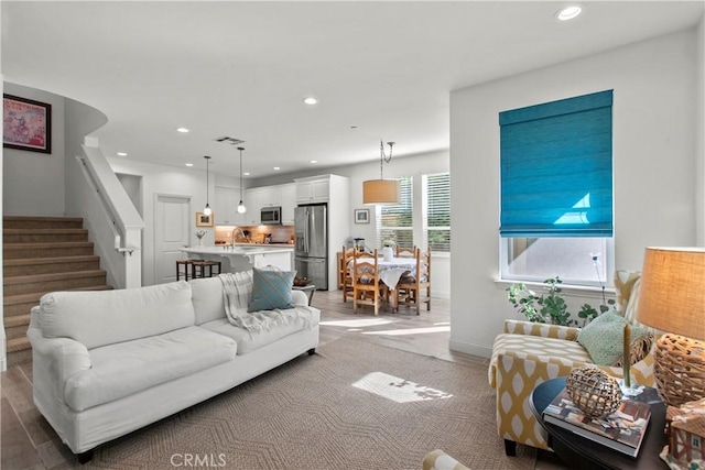 living room featuring sink and light hardwood / wood-style floors