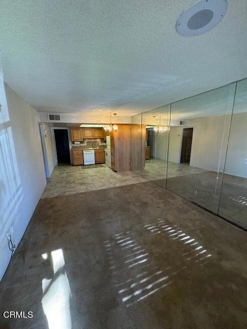 unfurnished living room with a textured ceiling