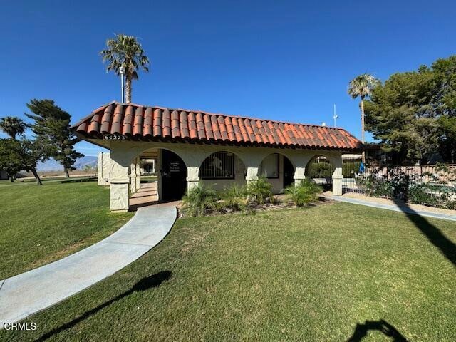 mediterranean / spanish-style house with a front yard