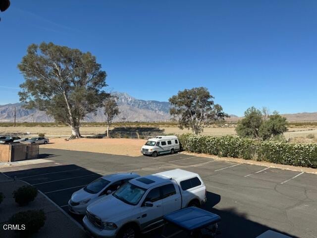 view of vehicle parking featuring a mountain view