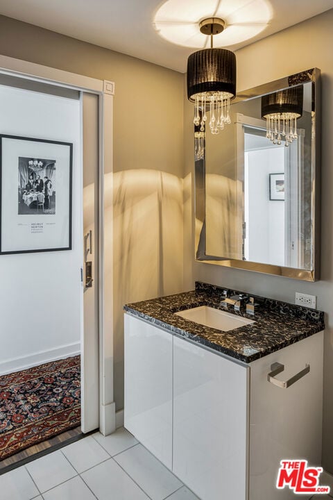 bathroom with tile patterned flooring and vanity