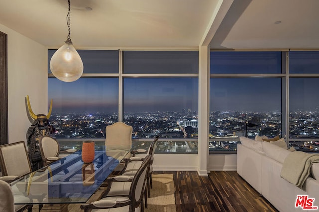 dining room featuring expansive windows and dark wood-type flooring