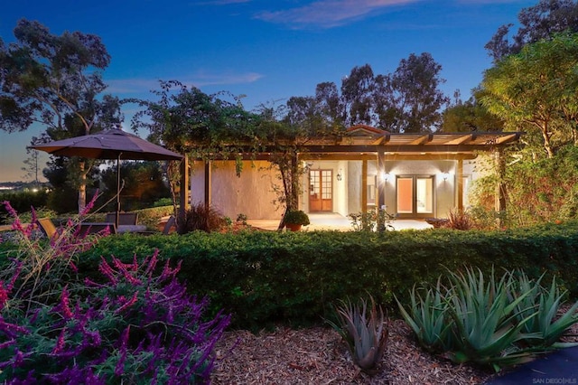 back house at dusk with french doors