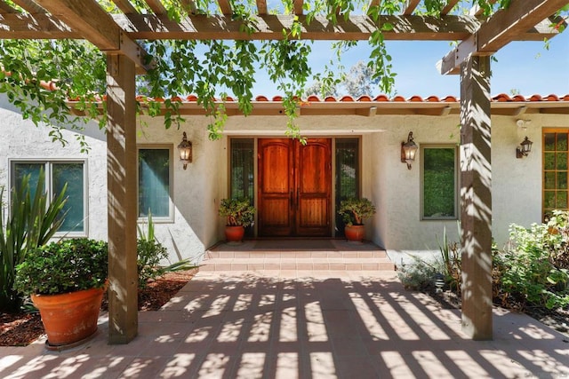 property entrance with a pergola