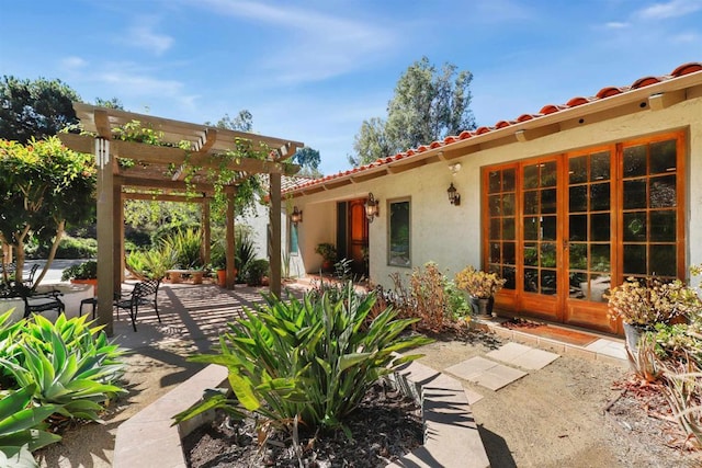 back of house featuring a patio area, a pergola, and french doors