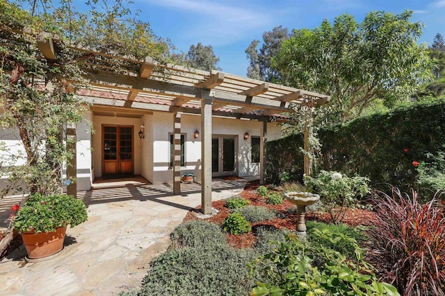 back of house featuring french doors and a pergola