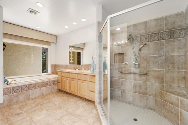 bathroom featuring tile patterned floors, vanity, and independent shower and bath