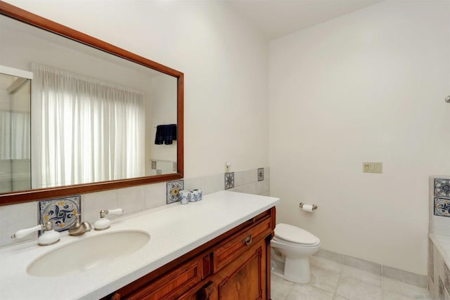 bathroom with toilet, vanity, and tile patterned floors