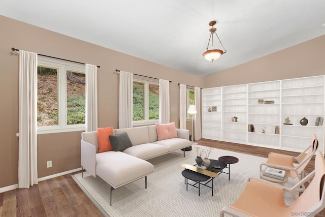 living room with plenty of natural light, wood-type flooring, and lofted ceiling