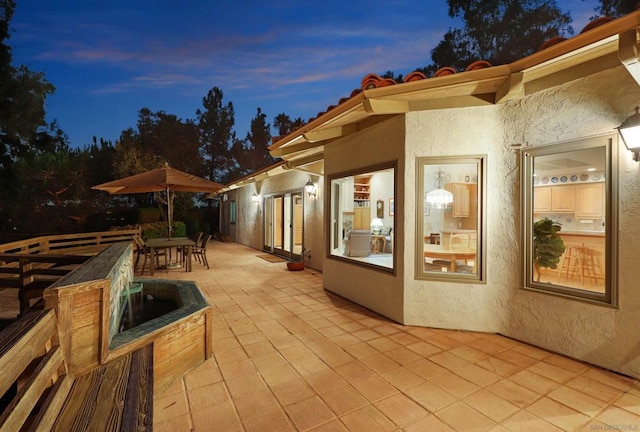 view of patio terrace at dusk