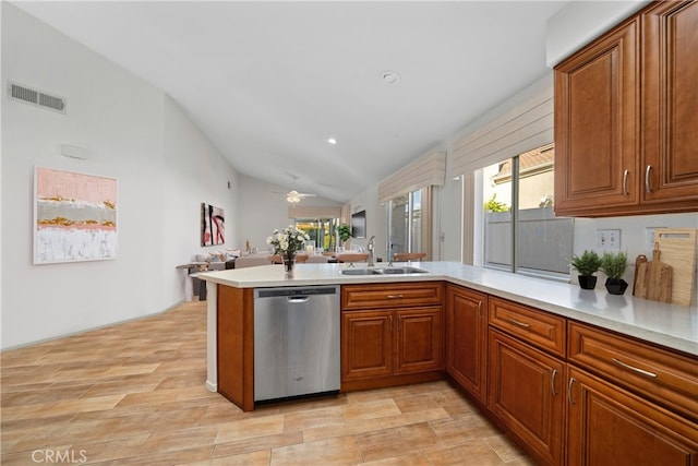 kitchen featuring sink, light wood-type flooring, kitchen peninsula, vaulted ceiling, and stainless steel dishwasher