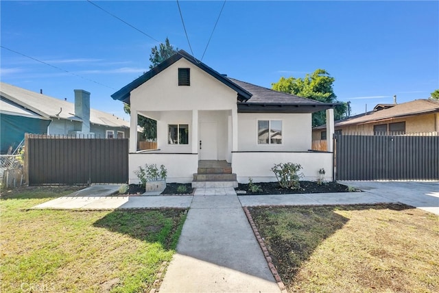 bungalow-style house with a front yard