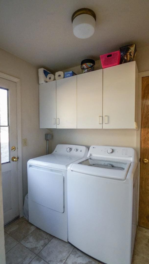 washroom featuring independent washer and dryer and cabinets