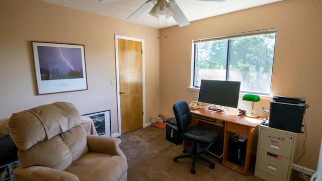 carpeted office featuring a textured ceiling and ceiling fan