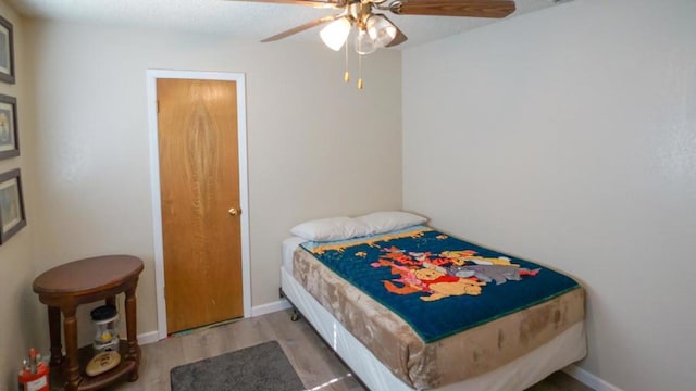 bedroom featuring ceiling fan and hardwood / wood-style flooring