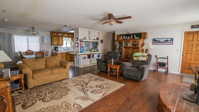 living room with dark wood-type flooring, a textured ceiling, and ceiling fan