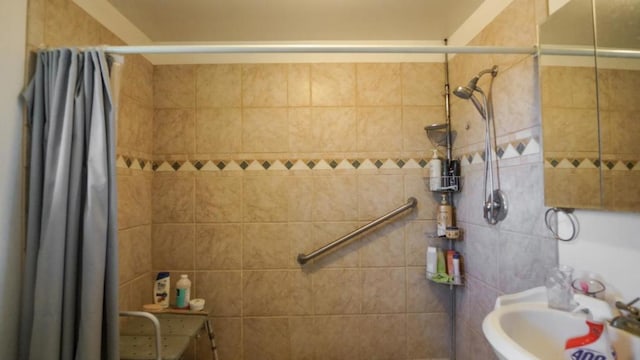 bathroom featuring walk in shower and sink