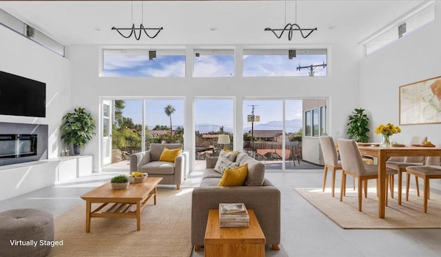 living room with a high ceiling and a notable chandelier