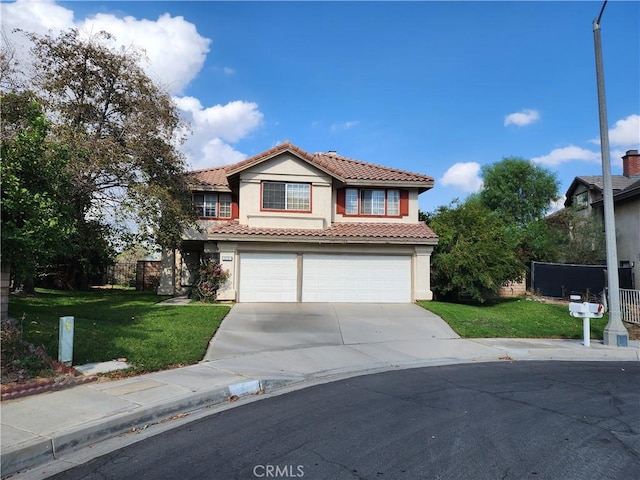 mediterranean / spanish-style house with a front lawn and a garage