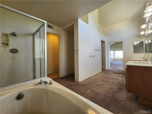 bathroom featuring a shower, a garden tub, double vanity, visible vents, and a sink