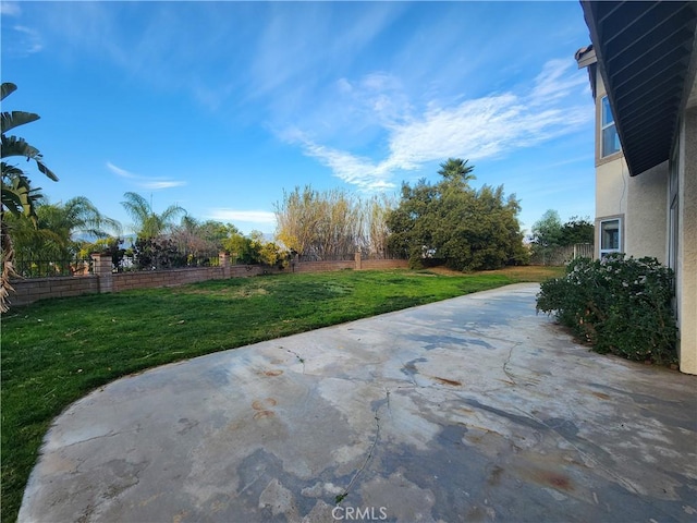 view of yard with fence and a patio