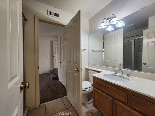 full bath featuring a stall shower, visible vents, toilet, tile patterned flooring, and vanity