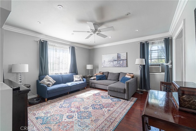 living room with dark wood-type flooring, ceiling fan, ornamental molding, and plenty of natural light