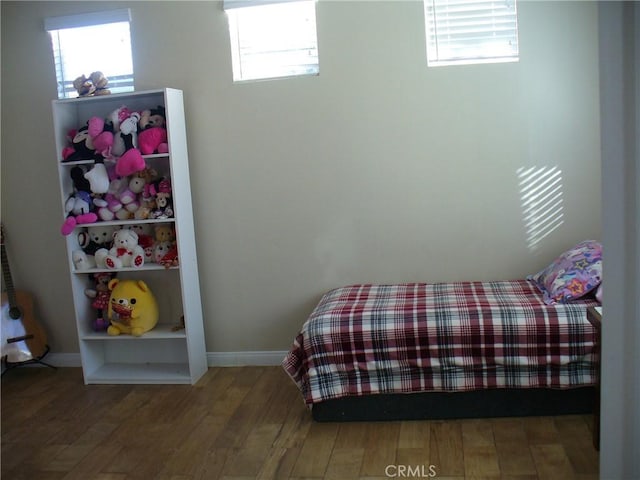 bedroom with hardwood / wood-style flooring