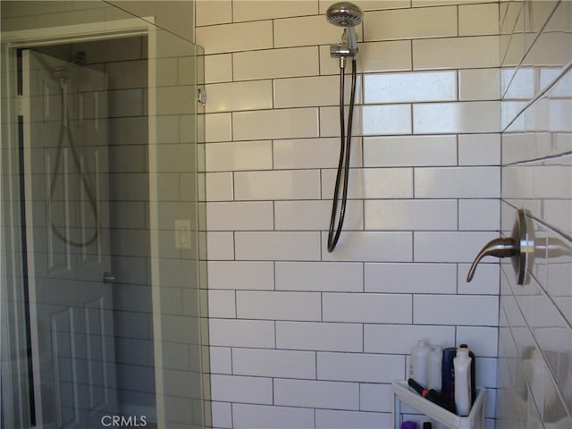 bathroom with tiled shower