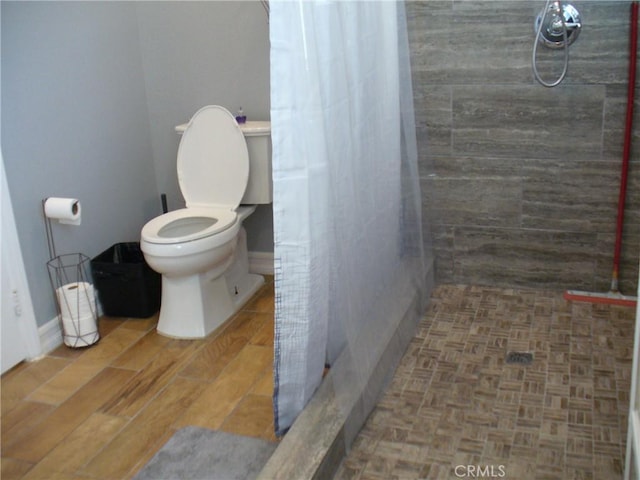 bathroom with walk in shower and toilet