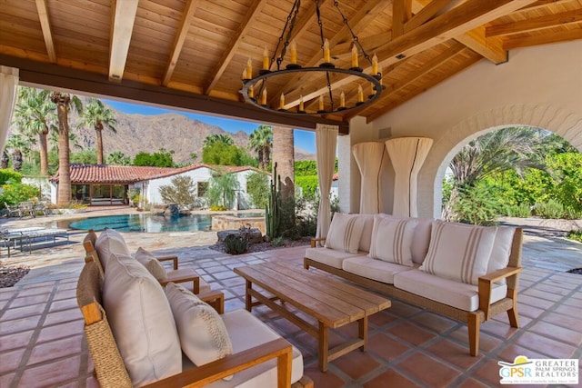 view of patio featuring a mountain view, ceiling fan, and an outdoor hangout area