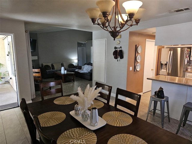 tiled dining room featuring a chandelier