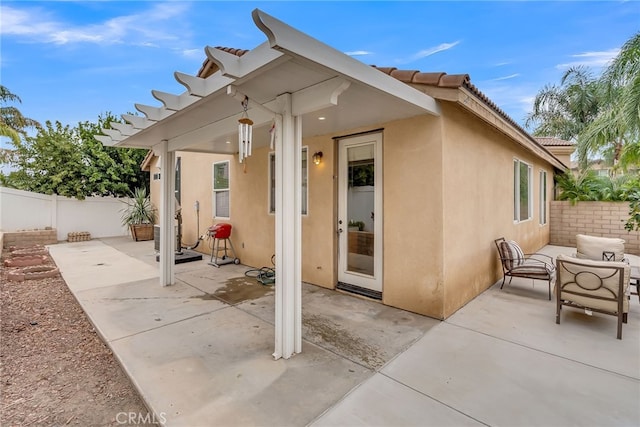 rear view of property featuring an outdoor living space and a patio