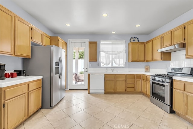 kitchen with sink, light tile patterned floors, and stainless steel appliances