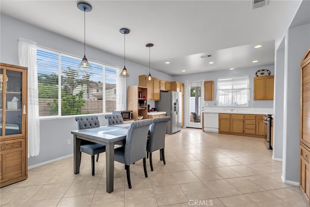 dining area with light tile patterned floors and sink