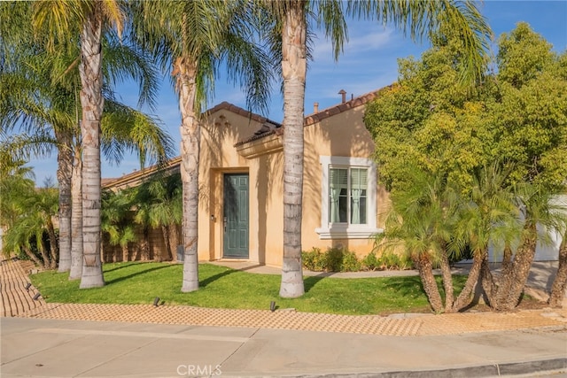 mediterranean / spanish-style home featuring a front yard