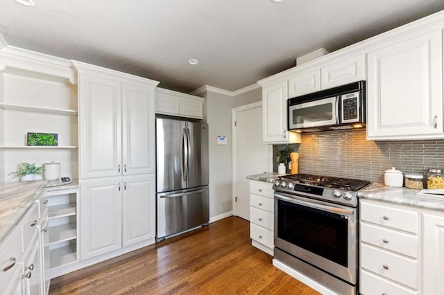 kitchen featuring decorative backsplash, white cabinetry, dark hardwood / wood-style floors, and appliances with stainless steel finishes